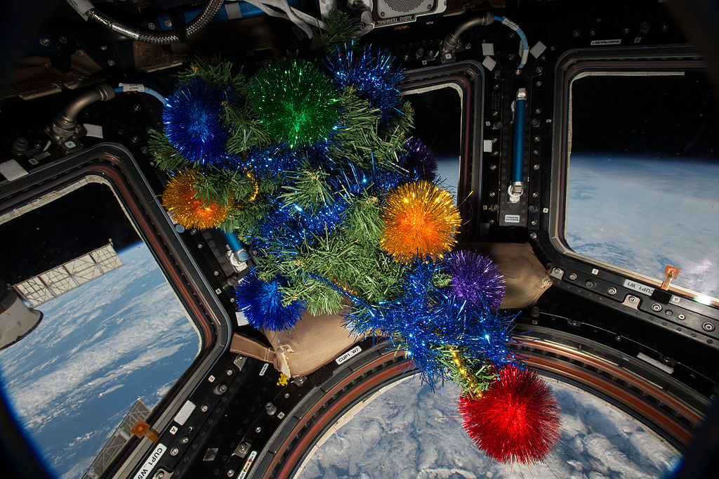 Photo of an Earth-viewing area of the International Space Station with holiday decorations.