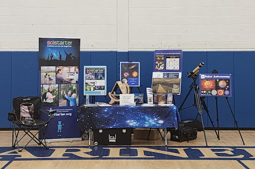 Webster's table at an event featuring citizen science projects.