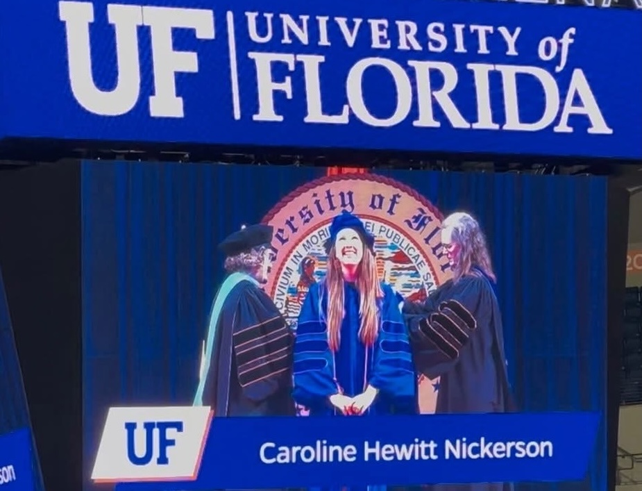 Photo of Caroline Nickerson in graduation gown at University of Florida