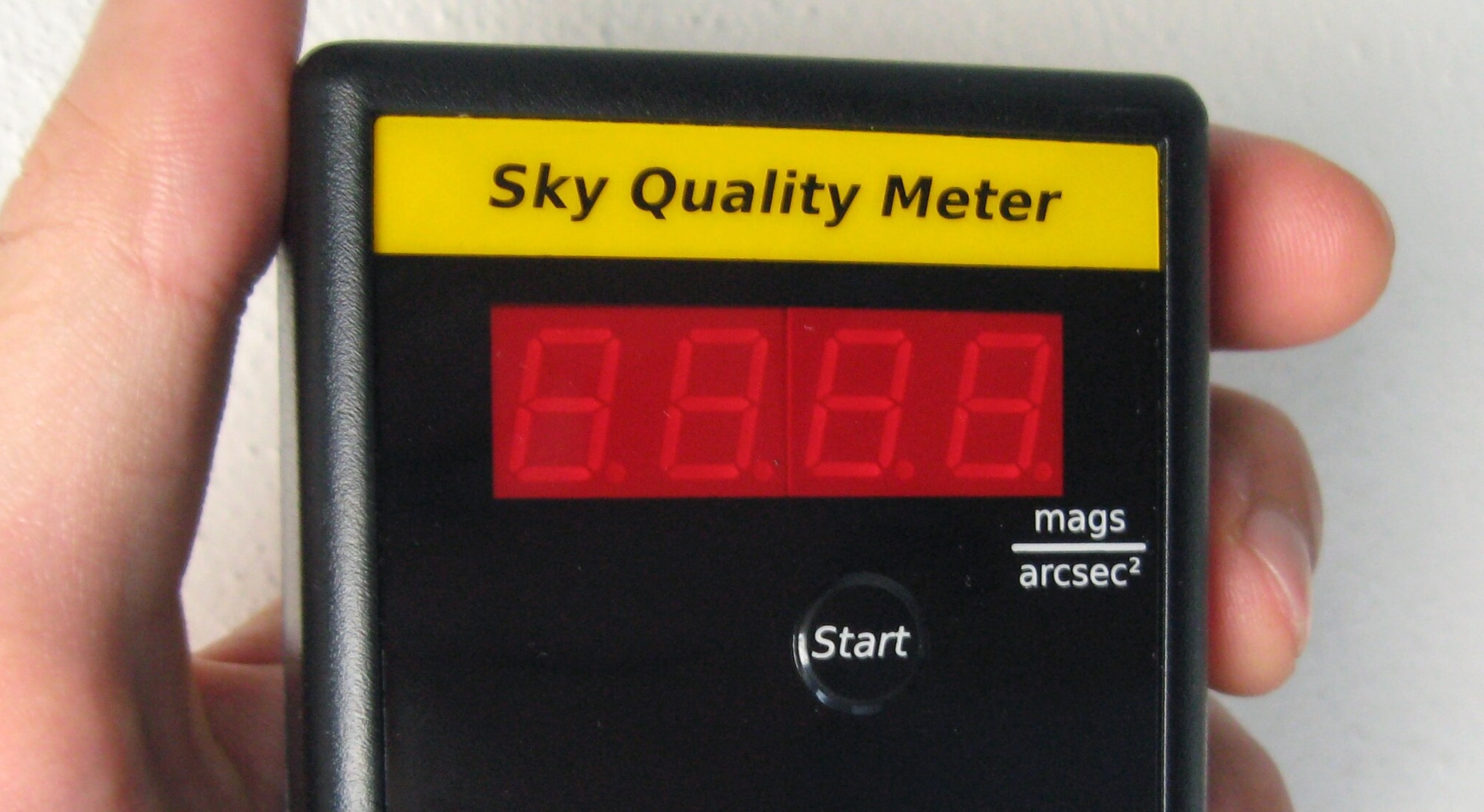 Hand held Sky Quality Meter, black box with red LED readout.